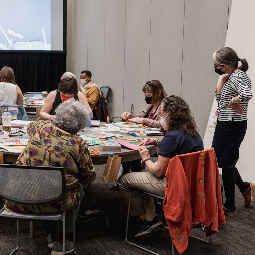 A group of people learning a quilting technique at QuiltCon 