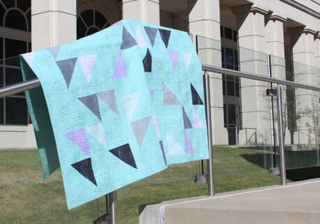 Teamworm quilt by Michelle White. Mint green, black, purples and grey triangle quilt
